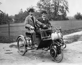 1900s Two Men In Bowler Hats Sitting In Three Wheel Motorized Horseless Carriage